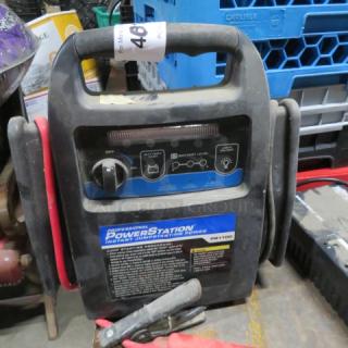 Portable Power Station PS1100 for instant jump starting with clamps, in used condition. Visible labels detail usage instructions.