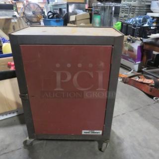 Metal tool cabinet on casters with a red front door. Features a sturdy build and visible wear. Label reads "Tool Cabinet."