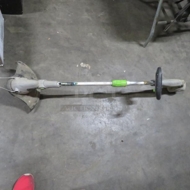 One Earth Wise Weed Eater, electric, green and silver, with handle and guard, used condition, visible wear.