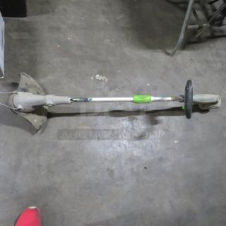 One Earth Wise Weed Eater, electric, green and silver, with handle and guard, used condition, visible wear.