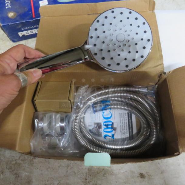 New Kiieyna shower head shown with packaging. Includes chrome handheld unit, hose, and mounting brackets.
