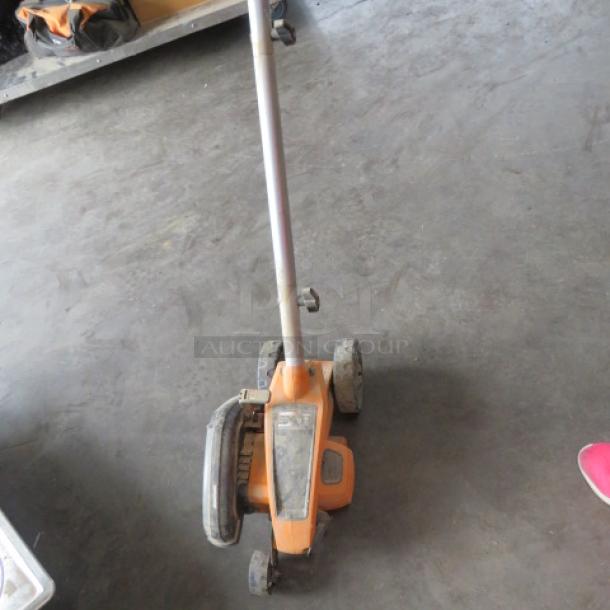 WORX Cordless Edger, Model WG396, 120 Volt, orange and black, used condition, showing handle and wheels.