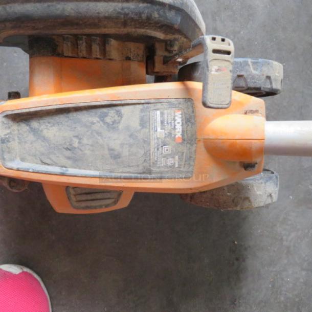 WORX Cordless Edger WG396, 120V, used condition, visible wear on orange body, label with brand and model details.