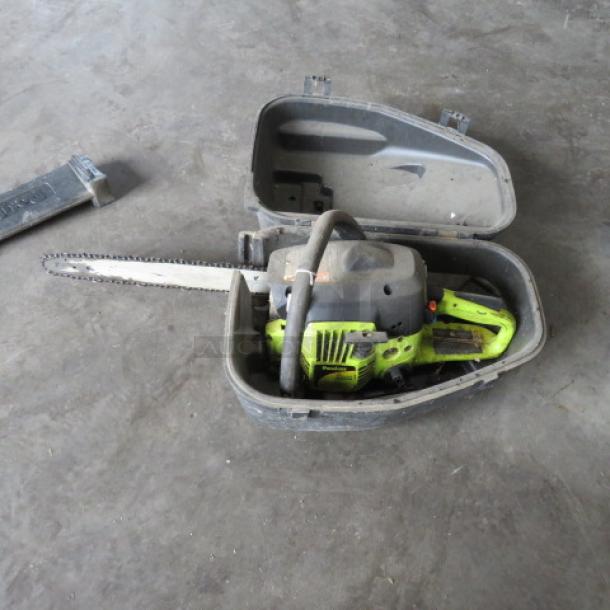 Poulan chainsaw in hard case, green and black, used condition. Visible bar and chain, includes protective case.