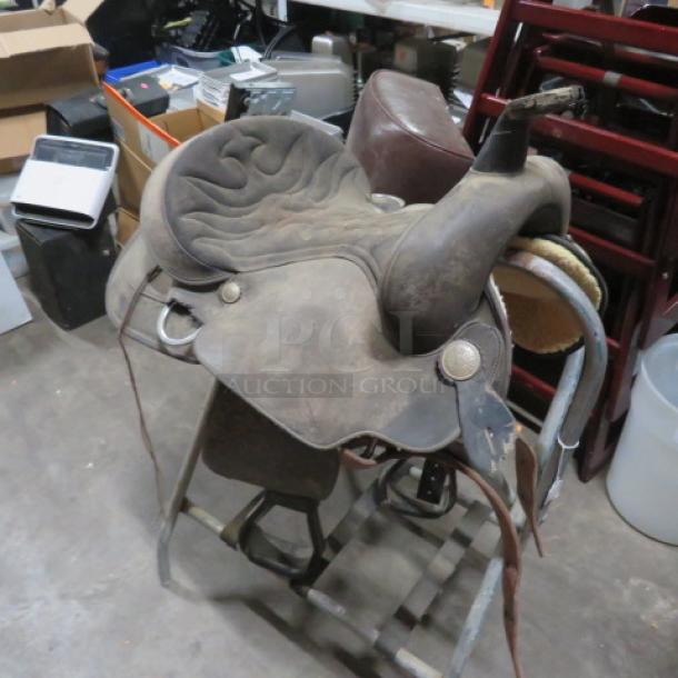 Wintec saddle in used condition, featuring a synthetic seat and metal stirrups, ideal for horseback riding enthusiasts.