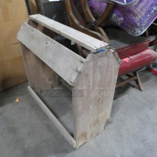 Wooden saddle stand, rustic finish, sturdy construction, visible wood grain, suitable for saddle display or storage.