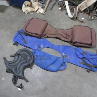 Assorted saddle bags in varied colors and sizes; features include pockets, adjustable straps, and durable material. Good condition.