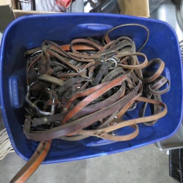 Blue bin filled with assorted leather straps, various lengths and conditions, with visible buckles and clasps.