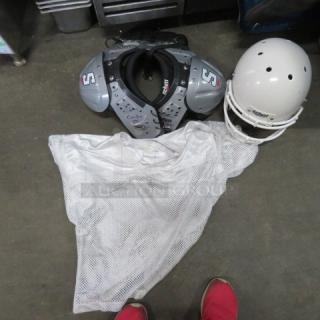 Lot of football gear includes shoulder pads, white helmet, and a white mesh jersey. Pads marked with "S" and brand labels.