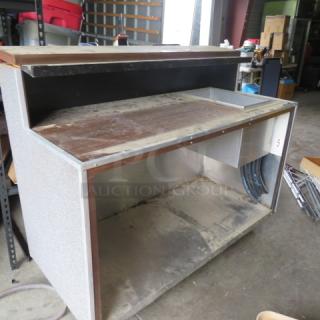 Portable bar with cold well, 61x28x50 inches. Features 12x19x10.5 cold well, under shelf, on casters. Used condition.