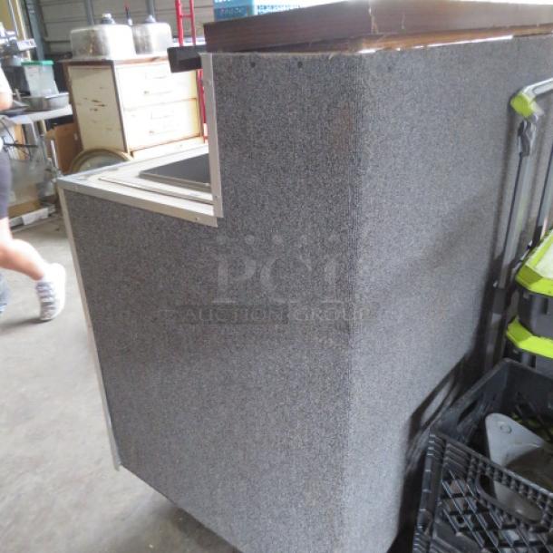 Gray portable bar with cold well, 12x19x10.5, undershelf, on casters. Dimensions 61x28x50. Good condition.
