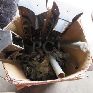 Box of assorted miscellaneous metal parts, including brackets and pipes, in used condition.