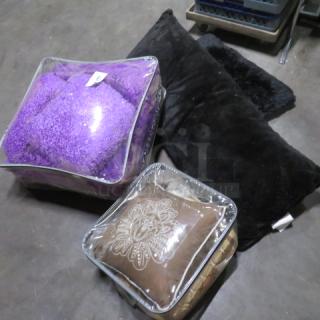 A collection of assorted cushions in protective plastic bags; featuring purple and brown designs, suitable for interior decor.