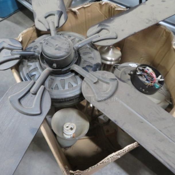 One lot of assorted lighting, including a box of ceiling fan parts and various fixtures, in used condition.