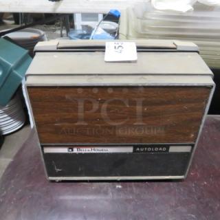 Vintage Bell & Howell Super 8 silent movie projector, model #461. Features wood paneling, autoload mechanism; good condition.