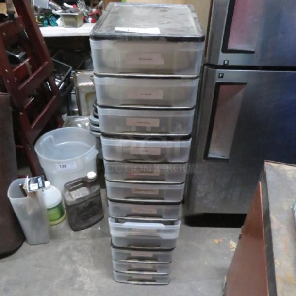 Stack of transparent poly organizer drawers, 10 units, labeled for contents. Used condition, suitable for storage.
