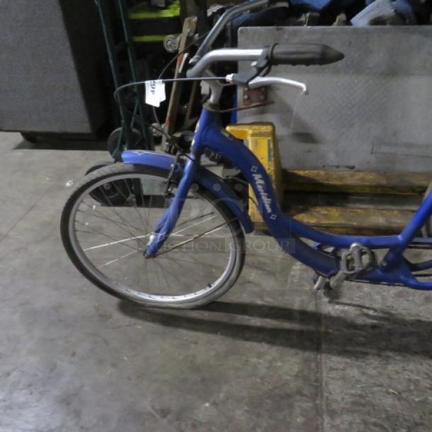 Vintage blue Schwinn Meridian tricycle, features rear basket, classic design. Good condition with visible frame markings.