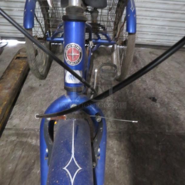 Vintage Schwinn Meridian tricycle, blue, with rear basket. Features original Schwinn badge. Good condition.