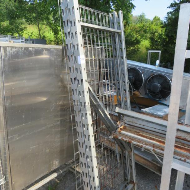 One lot of pallet racking with metal frames and wire mesh, showing signs of use and rust, suitable for industrial storage.