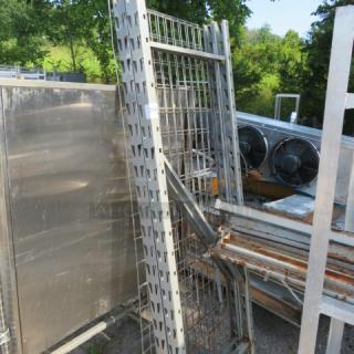 One lot of pallet racking with metal frames and wire mesh, showing signs of use and rust, suitable for industrial storage.