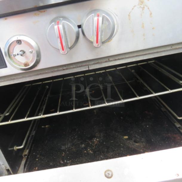 Southbend S361D gas range oven interior with one rack, visible control knobs, moderate wear.