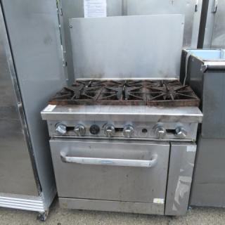 Cookrite 6 burner natural gas range on casters, stainless steel, visible wear, ideal for commercial kitchens.