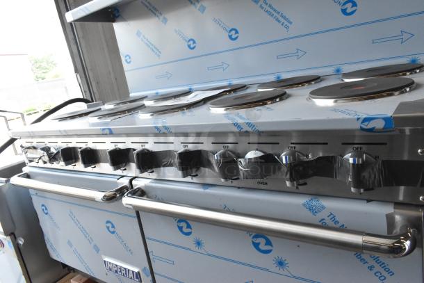 Brand new Imperial stainless steel 10-burner hot plate range with two ovens, overshelf, and backsplash.