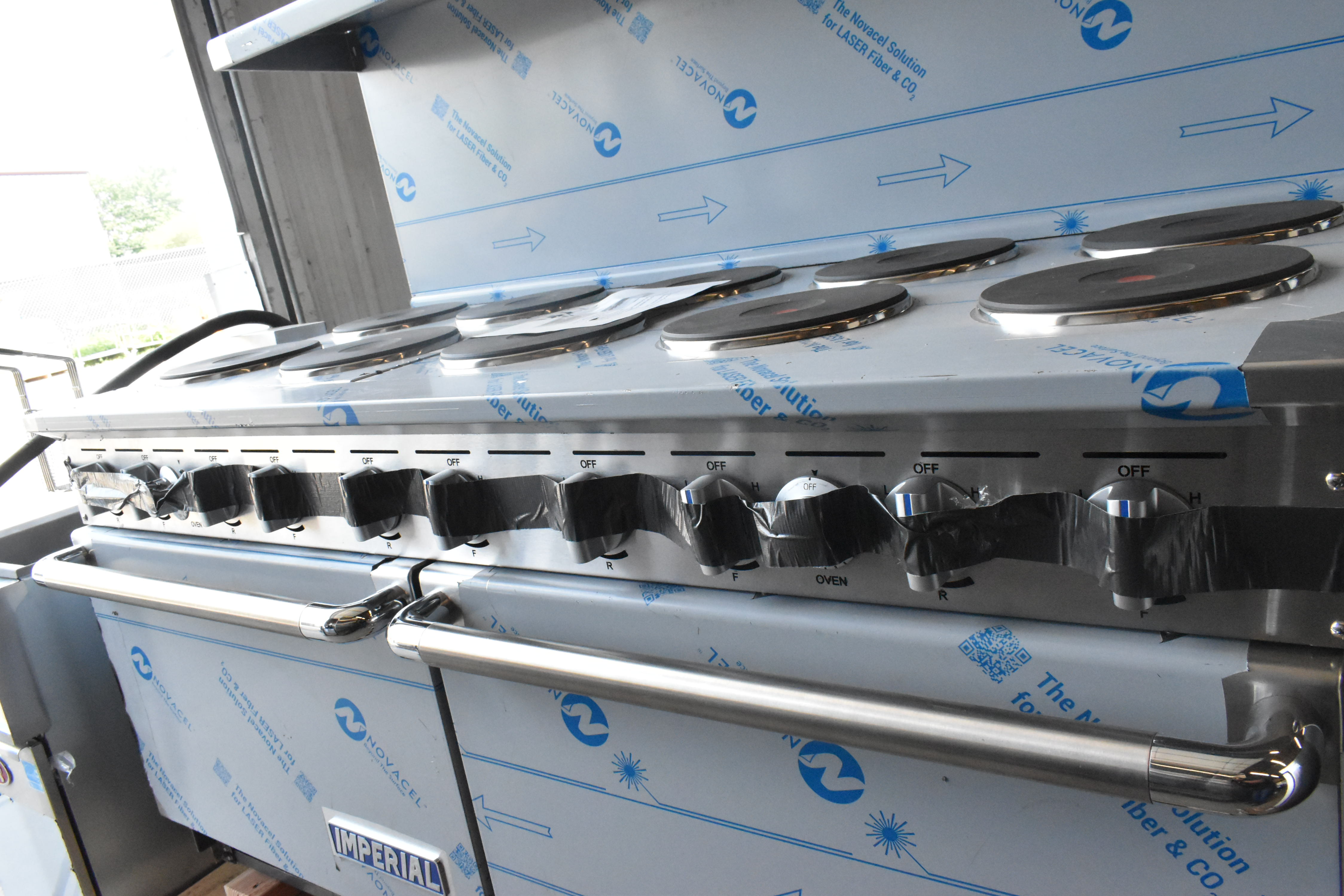 Commercial electric range control panel showing temperature dials