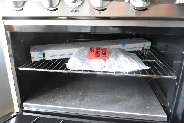 Brand new Imperial 10-burner hot plate range, stainless steel, electric, with 2 ovens. Includes overshelf and backsplash.
