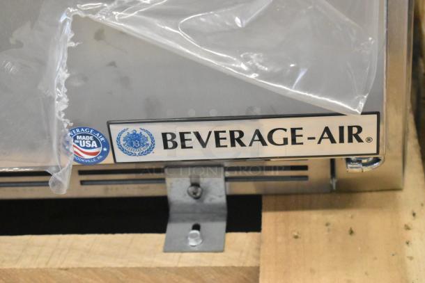 Stainless steel Beverage Air SPE27HC-12M prep table, new with scratch and dent, Made in USA label visible.