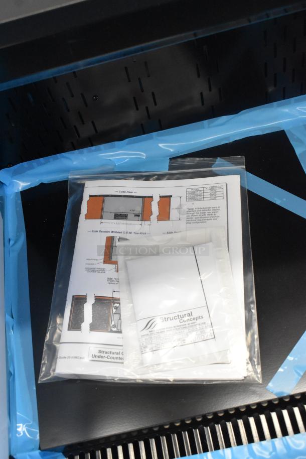 BRAND NEW SCRATCH AND DENT! Structural Concepts CO3324R undercounter air curtain merchandiser, shown with protective packaging and instruction manual.