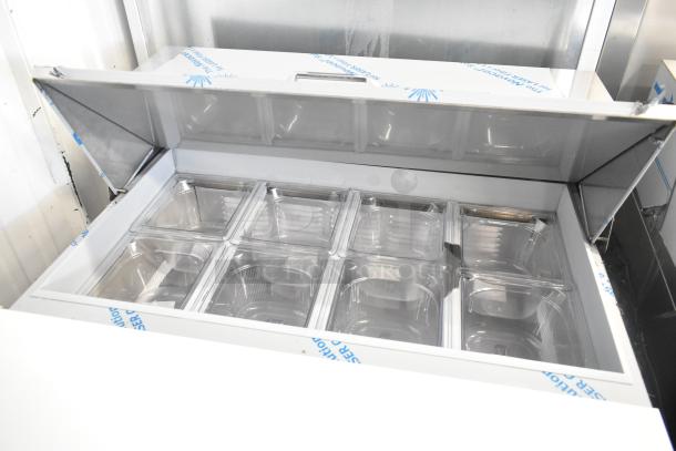 BRAND NEW Beverage Air SPE27HC-B stainless steel sandwich salad prep table, shown with open top and clear containers.