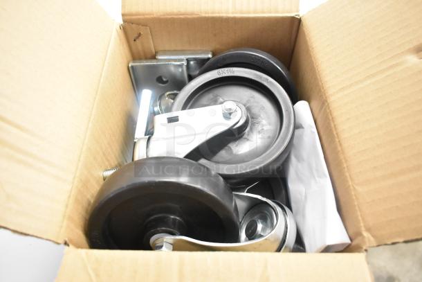 Cardboard box containing caster wheels and metal brackets for Beverage Air SPE27HC-B prep table.