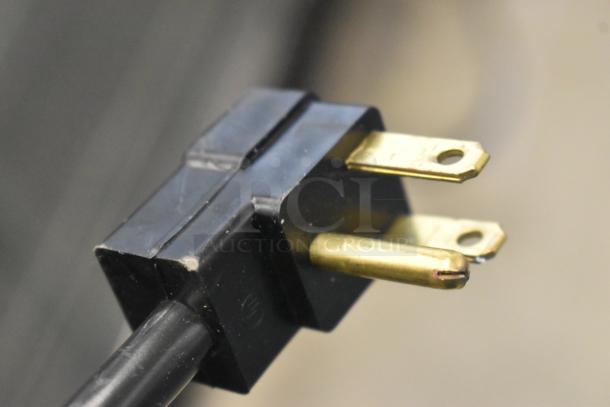 Close-up of a three-prong electrical plug for the Beverage Air UCFD60AHC-2 freezer, 115 volts, 1 phase.