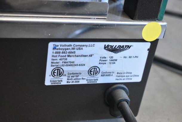 Label on a Vollrath Cayenne FMA7048 Heated Display Case showing model, voltage, and certification details. Brand new, scratch and dent.