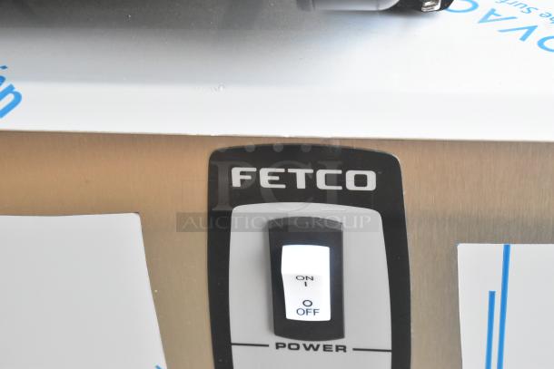 Stainless steel Fetco HWB-25 hot water dispenser, 25-gallon capacity, shown with power switch labeled "on/off".