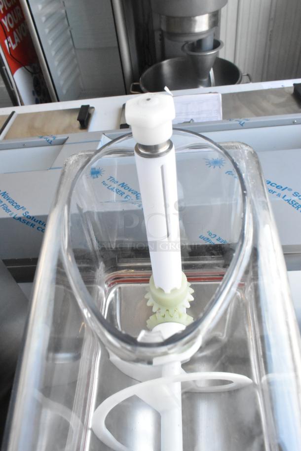 Brand new metal commercial countertop slushie machine with a single hopper. Slight scratch and dent visible.