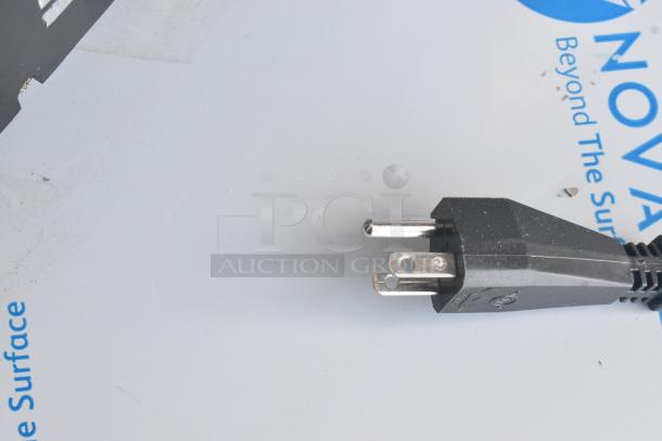 Power plug of a new scratch and dent metal commercial countertop single hopper frozen beverage slushie machine.