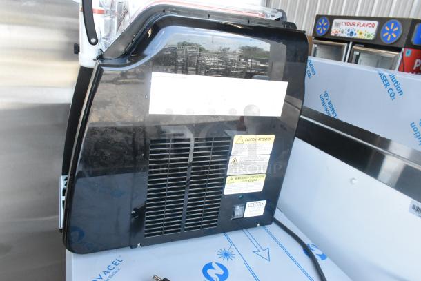 BRAND NEW SCRATCH AND DENT! Metal countertop single hopper frozen beverage slushie machine with caution labels and black exterior.
