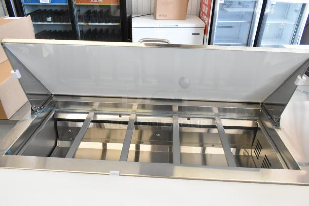 Brand new Avantco 178SSPT6010 stainless steel refrigerated sandwich prep table, open lid, stainless interior, on commercial casters.