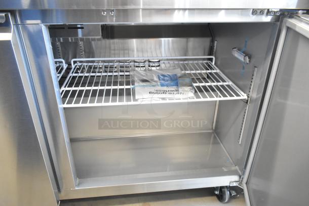 BRAND NEW Avantco 178SSPT6010 stainless steel two-door refrigerated sandwich prep table with casters, shown with open door.
