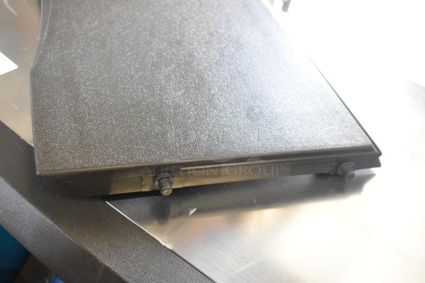 Close-up of a Manitowoc UDF0240A-161B ice machine part, showing a textured black surface and attachment points.