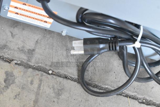 Power cord and warning labels on a Manitowoc UDF0240A-161B ice machine, 115 volts, 1 phase.