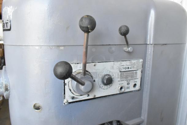 Hobart M-802 metal commercial 80-quart planetary dough mixer with control panel, levers, and wear. Model label visible.