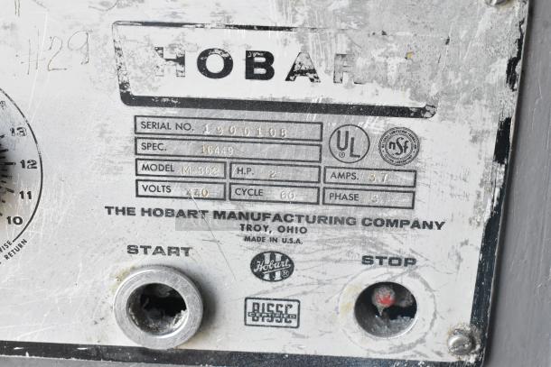 Hobart M-802 metal dough mixer label showing model number, 440V, 3 phase, made in Troy, Ohio, with start/stop buttons.