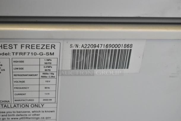 Thomson TFRF710-G-SM Chest Freezer label showing model, voltage 115V, serial number, and manufacturing details.