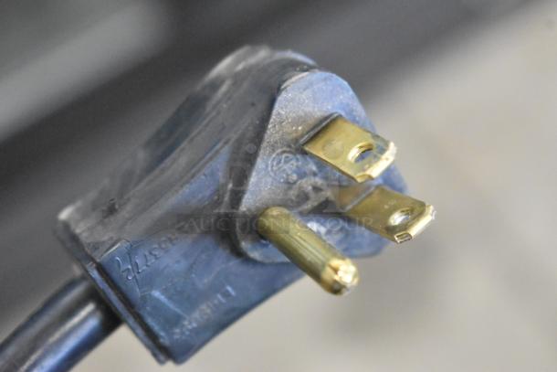 Close-up of a three-prong plug for the 2019 Habco SE18 cooler, featuring 115-volt power specification.