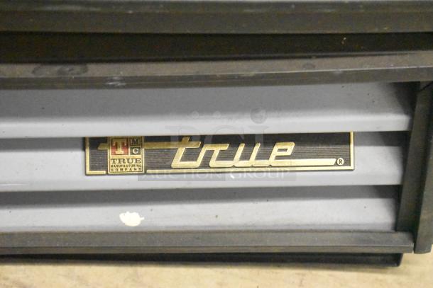 True GDM-12-LD cooler, metal frame, single door, poly-coated racks, 115V, 1 phase, True label visible.