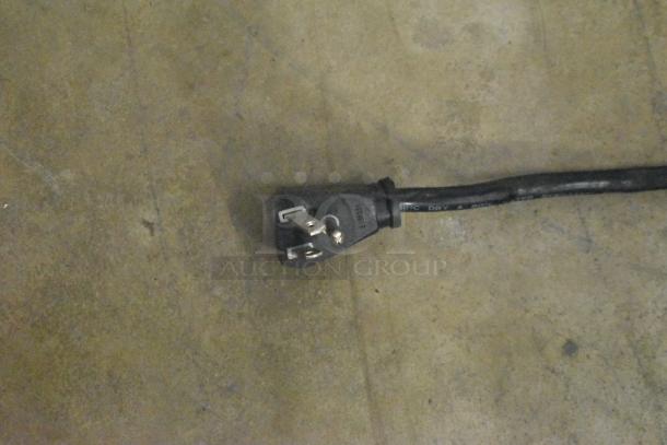 Power cord of the True GDM-12-LD cooler merchandiser, showing a three-prong plug, suitable for 115 volts, 1 phase.
