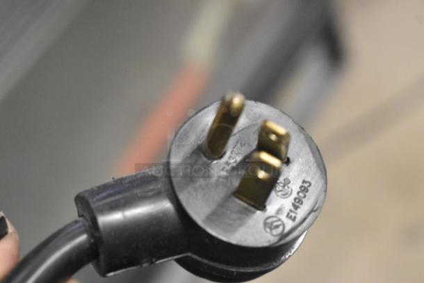 Close-up of a power plug for a 2019 Habco SE18 commercial cooler, showing electrical prongs and certification markings.